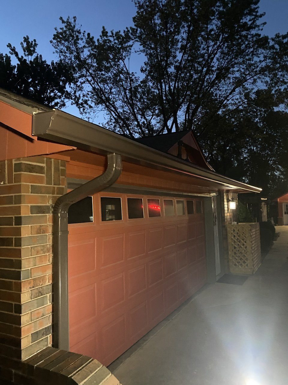 Musket-brown seamless gutters and downspout on a brick home